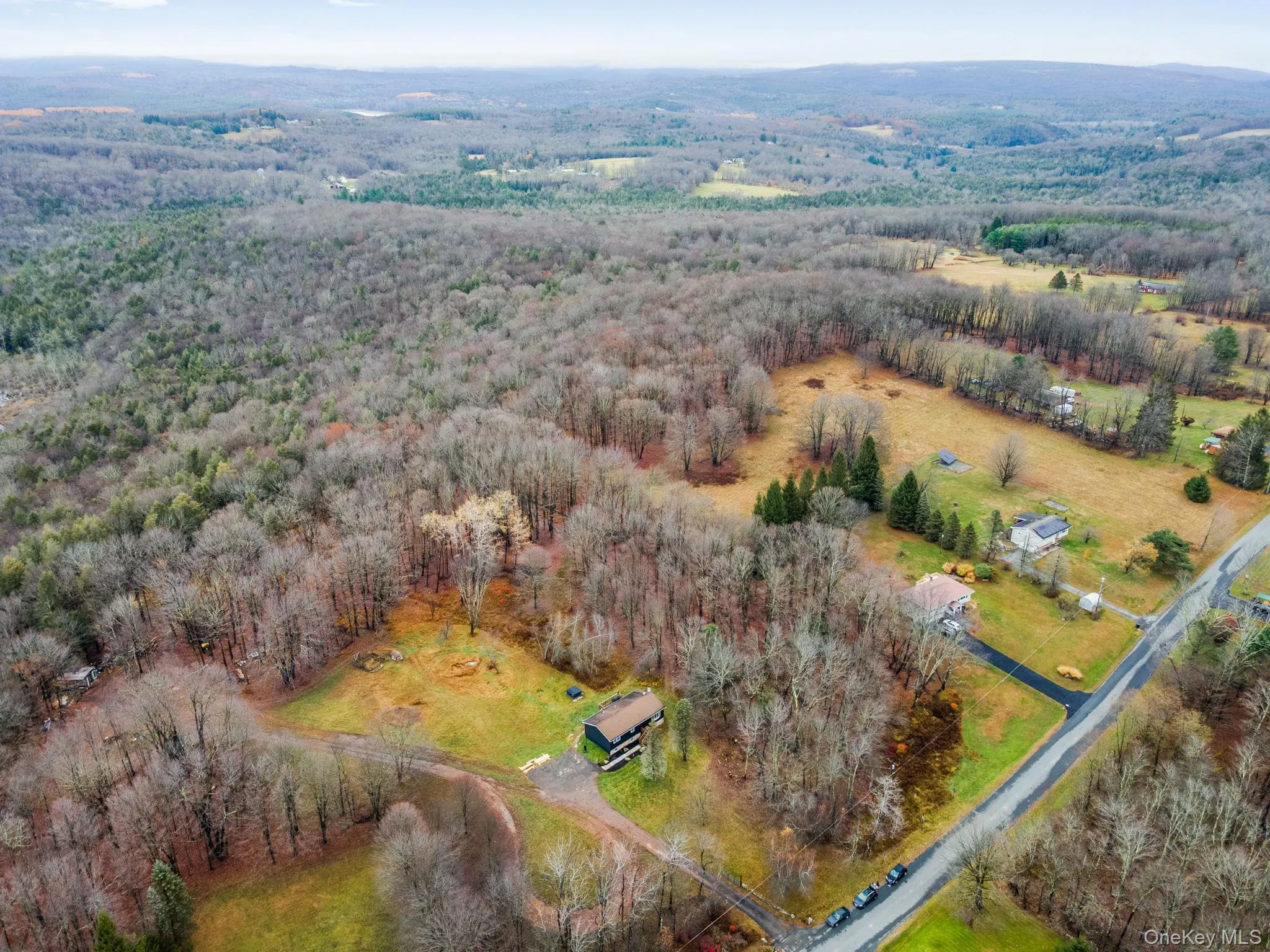 Aerial view of property and surrounding area featuring a forest Aerial view of property and surrounding area featuring a forest