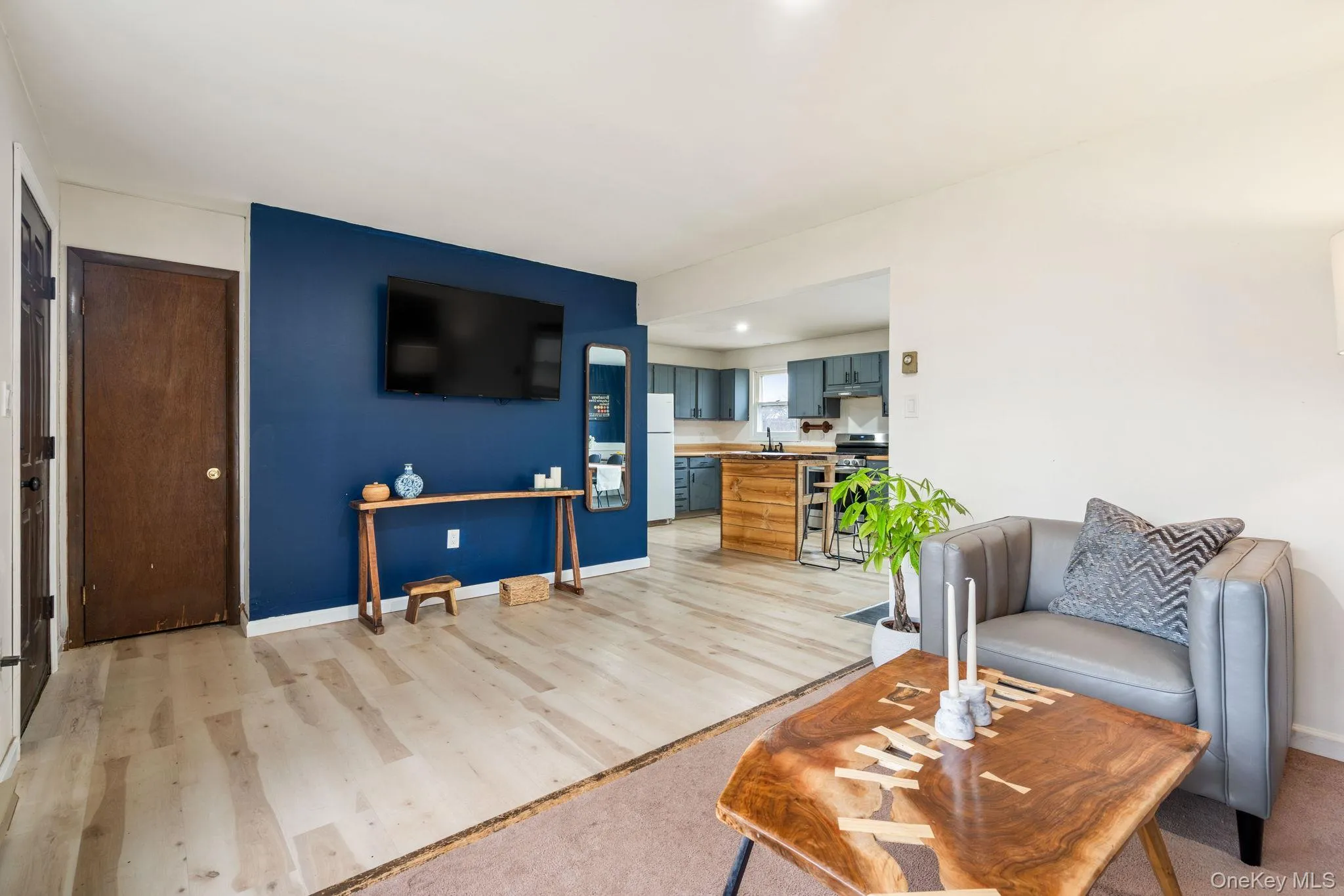 Living area featuring light wood-style flooring and recessed lighting Living area featuring light wood-style flooring and recessed lighting