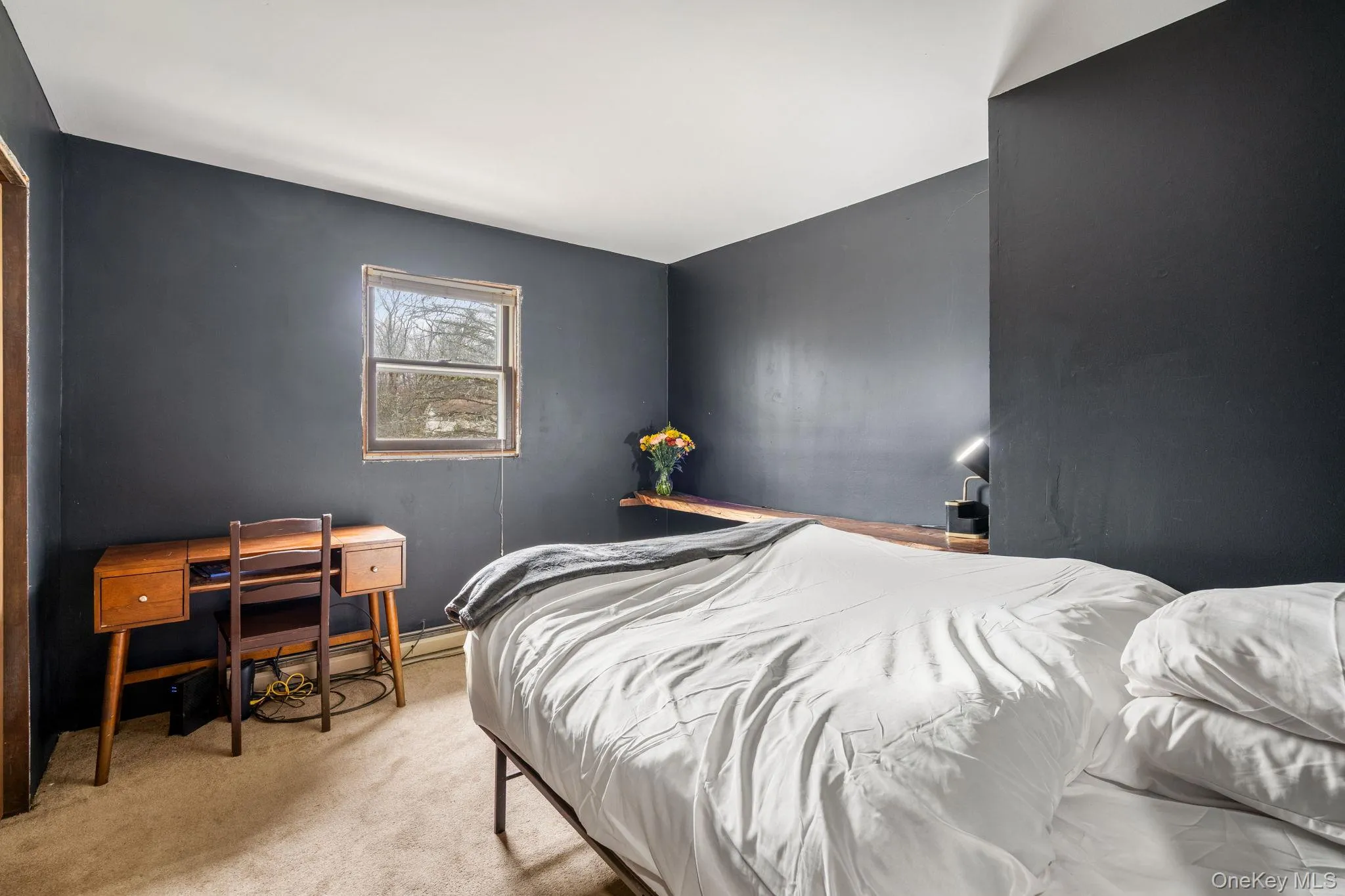 Carpeted bedroom featuring a desk Carpeted bedroom featuring a desk