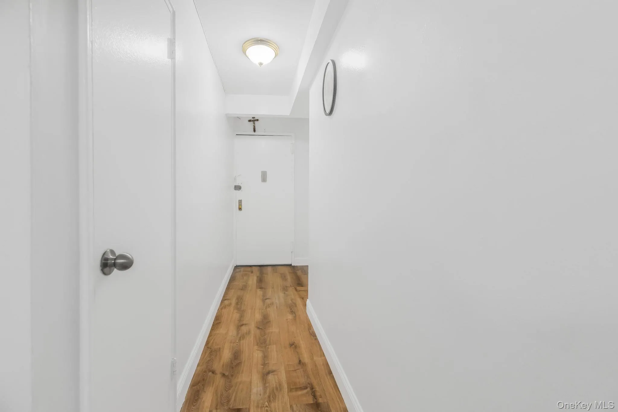 Corridor with wood finished floors and baseboards Corridor with wood finished floors and baseboards