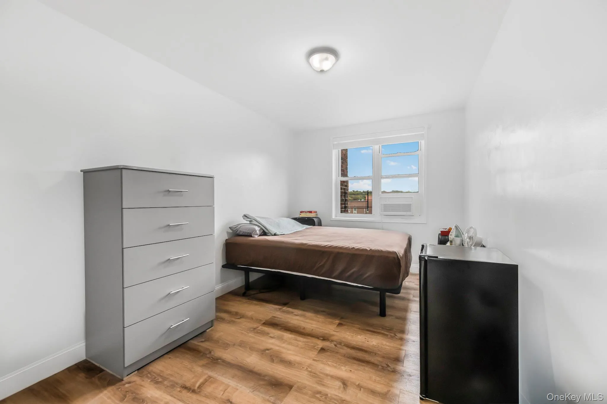 Bedroom featuring light wood finished floors and baseboards Bedroom featuring light wood finished floors and baseboards