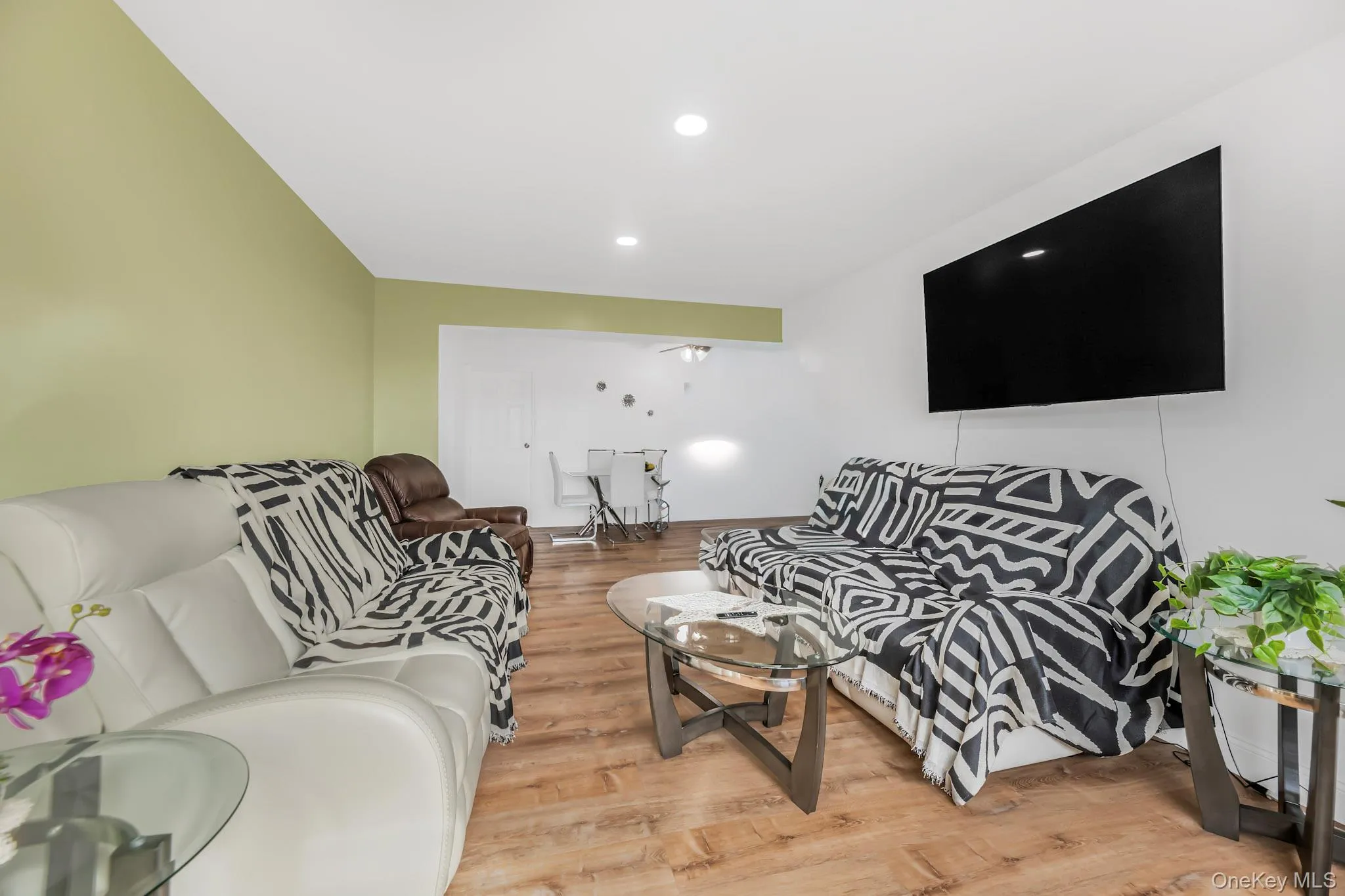 Living room featuring light wood-style floors and recessed lighting Living room featuring light wood-style floors and recessed lighting