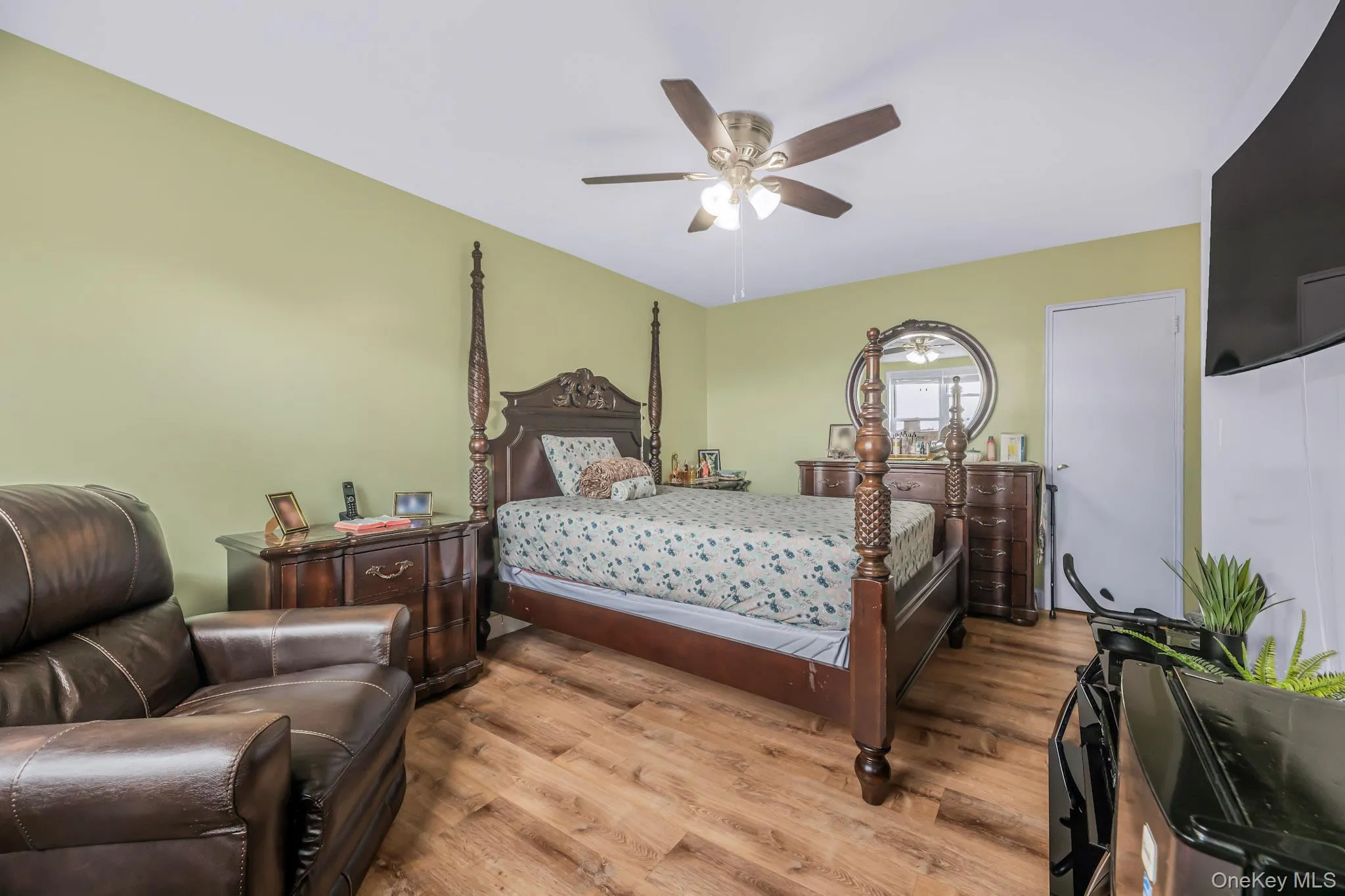 Bedroom with wood finished floors and ceiling fan Bedroom with wood finished floors and ceiling fan