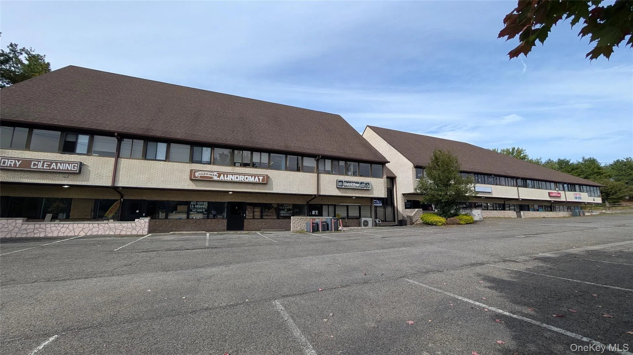 View of building exterior with uncovered parking View of building exterior with uncovered parking