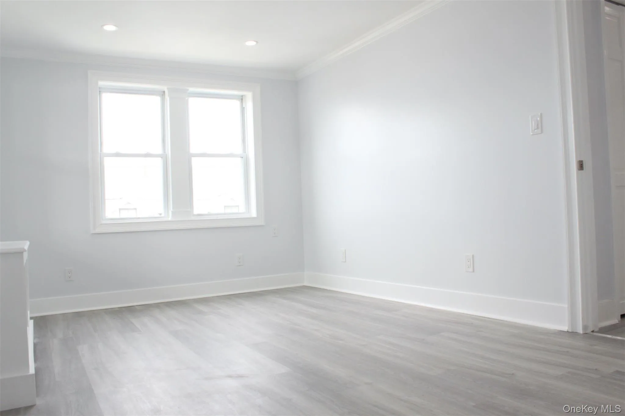 Unfurnished bedroom with light wood-style floors and crown molding Unfurnished bedroom with light wood-style floors and crown molding