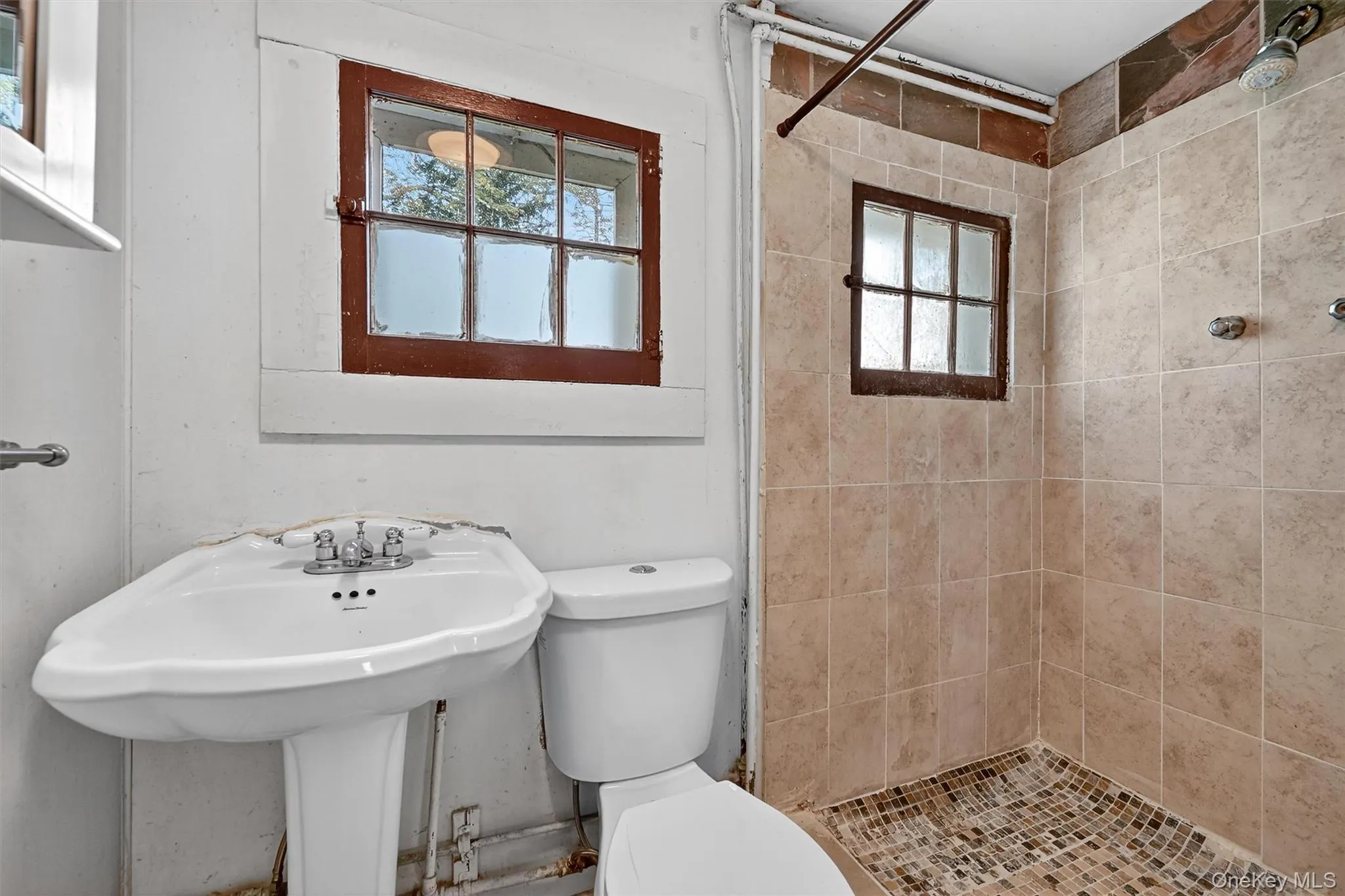 Full bath with a shower stall and plenty of natural light Full bath with a shower stall and plenty of natural light