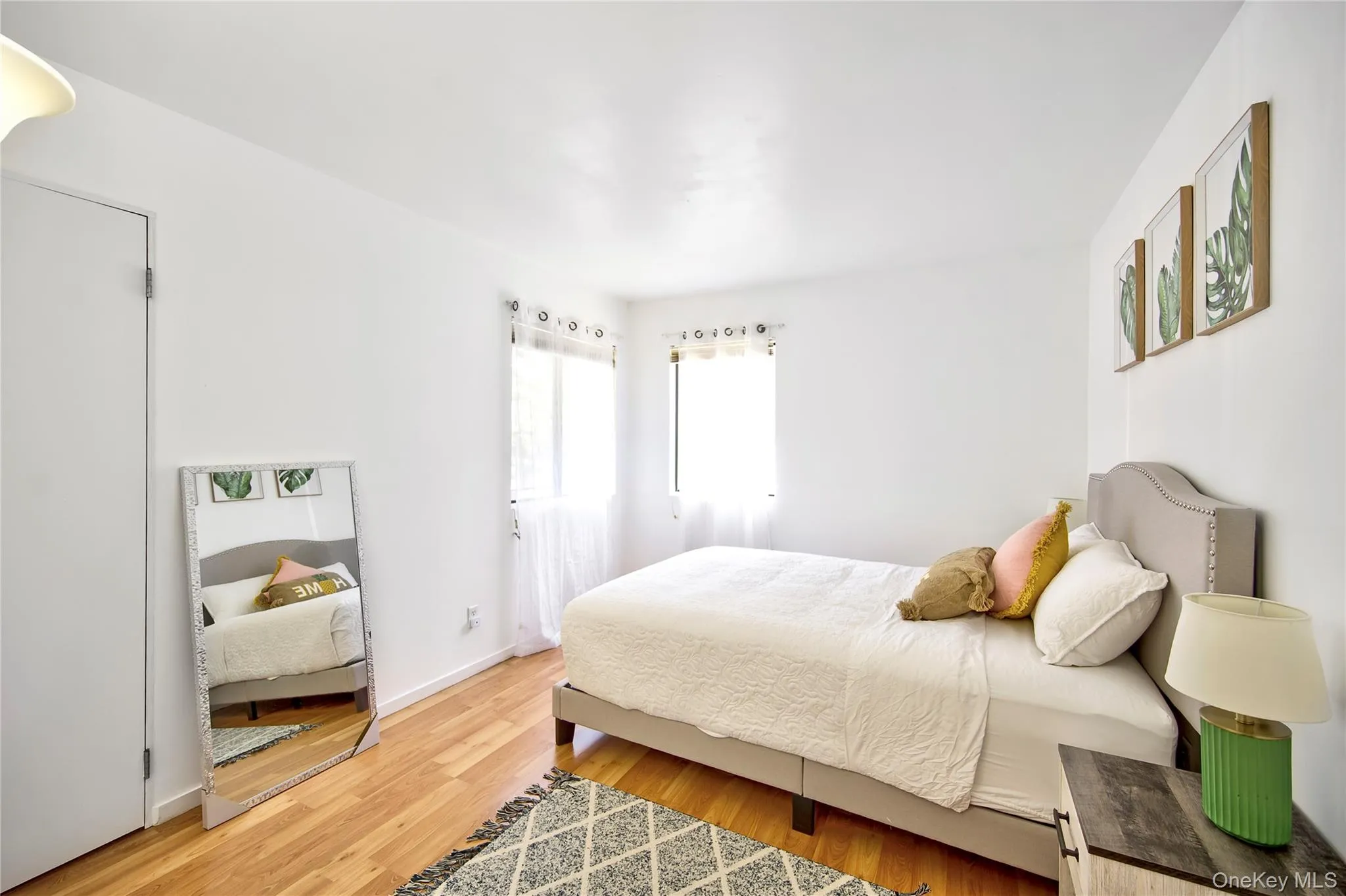 Bedroom featuring light wood-style flooring and baseboards Bedroom featuring light wood-style flooring and baseboards