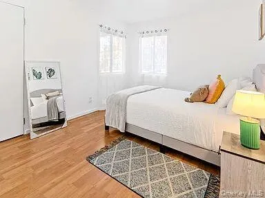 Guest Bedroom featuring light wood-style flooring and baseboards Guest Bedroom featuring light wood-style flooring and baseboards