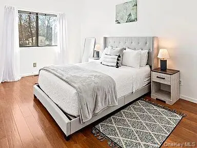 Bedroom with wood finished floors and baseboards Bedroom with wood finished floors and baseboards