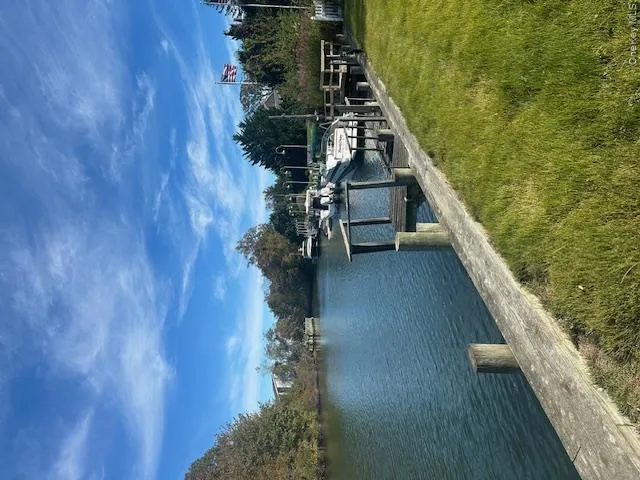 Dock area with a lawn and a water view Dock area with a lawn and a water view