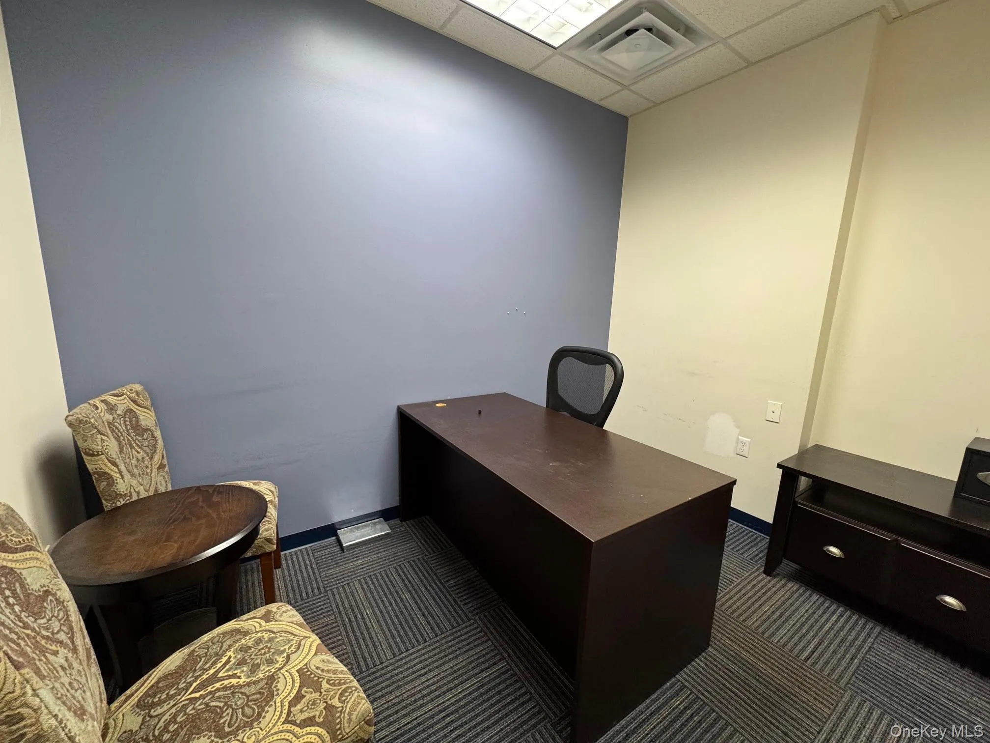 Office area with drop ceiling and dark carpet Office area with drop ceiling and dark carpet