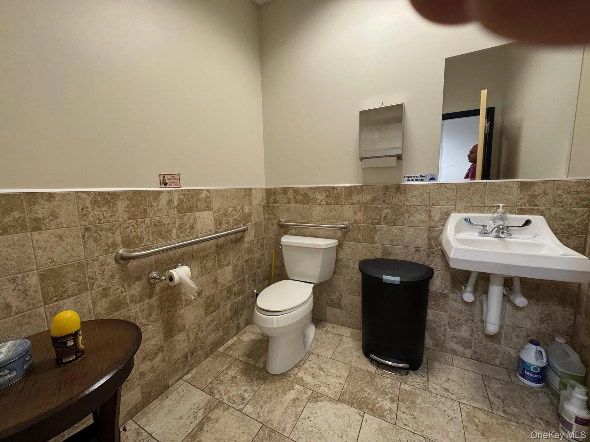 Half bathroom with tile walls, and tile patterned floors Half bathroom with tile walls, and tile patterned floors