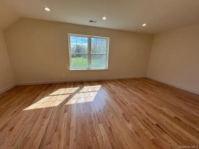 Additional living space with recessed lighting and light wood-type flooring Additional living space with recessed lighting and light wood-type flooring