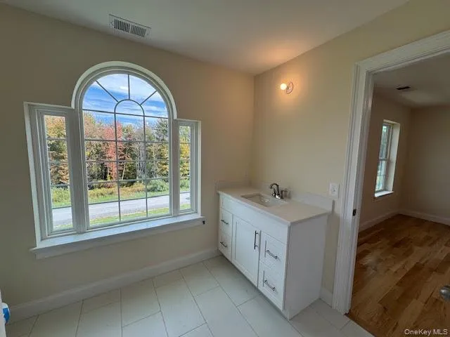 Bathroom featuring vanity and baseboards Bathroom featuring vanity and baseboards
