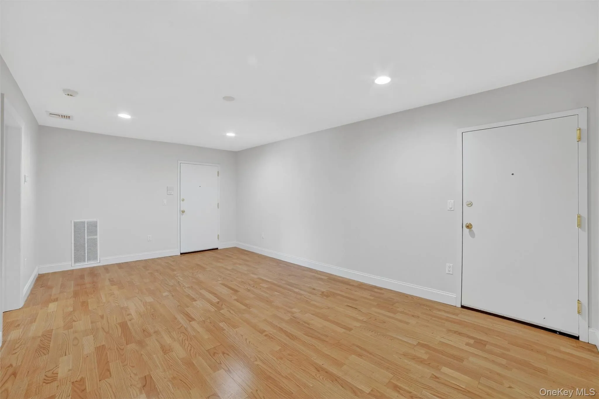 Enter into the living room/dining area with 2 doors to access the apartment from common hallways. Enter into the living room/dining area with 2 doors to access the apartment from common hallways.