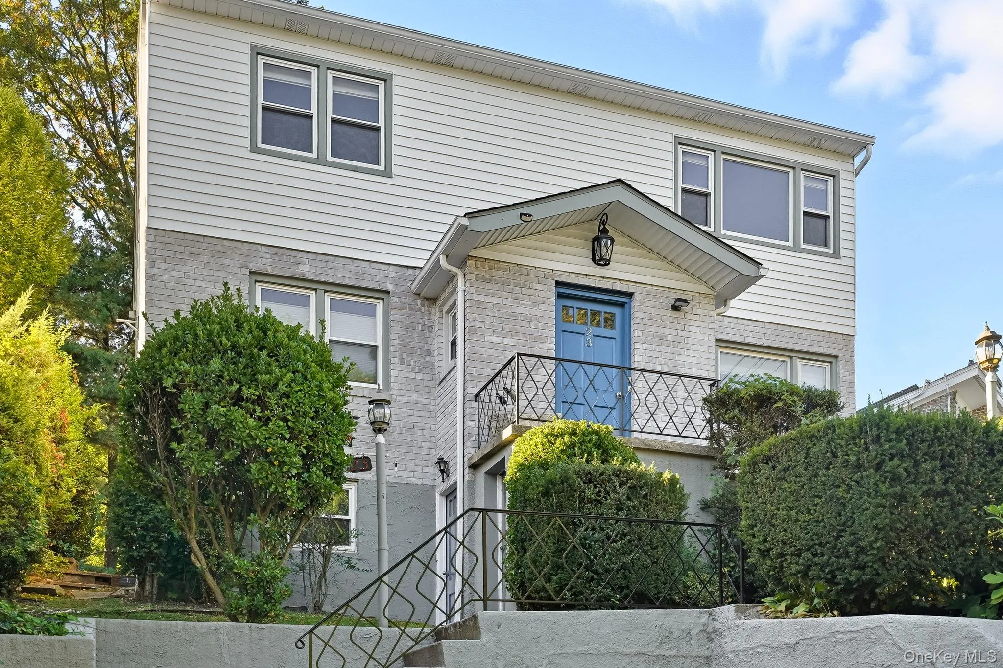 Traditional-style house featuring brick siding and stairs Traditional-style house featuring brick siding and stairs