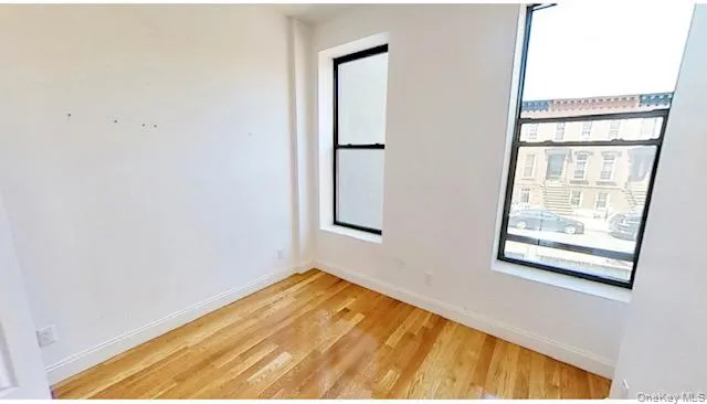 Unfurnished room featuring baseboards and light wood finished floors Unfurnished room featuring baseboards and light wood finished floors