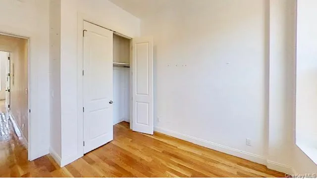 Unfurnished bedroom with light wood-style floors and a closet Unfurnished bedroom with light wood-style floors and a closet