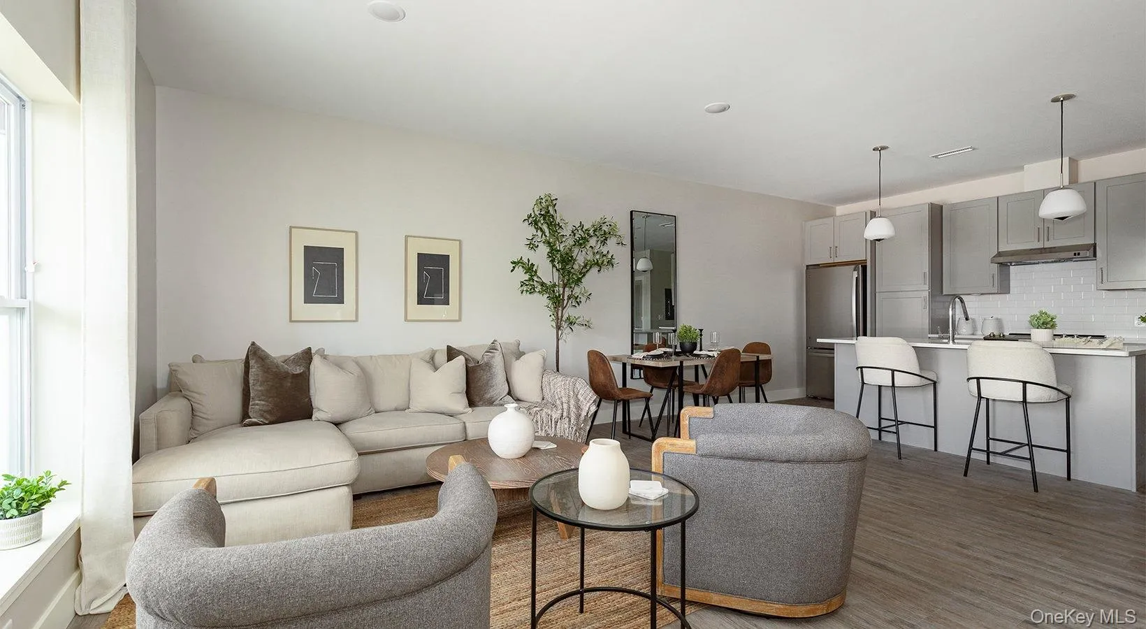 Living area with light wood-style floors and plenty of natural light Living area with light wood-style floors and plenty of natural light