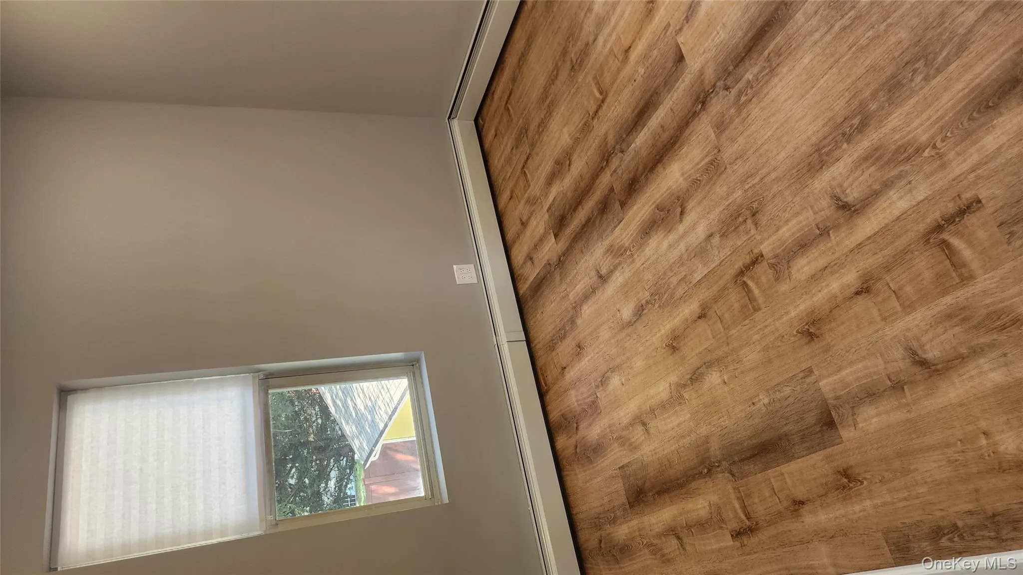 Unfurnished room with baseboard heating and light wood-style floors Unfurnished room with baseboard heating and light wood-style floors