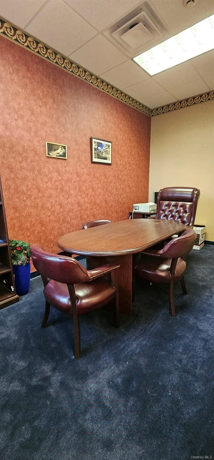 Office area with a paneled ceiling Office area with a paneled ceiling