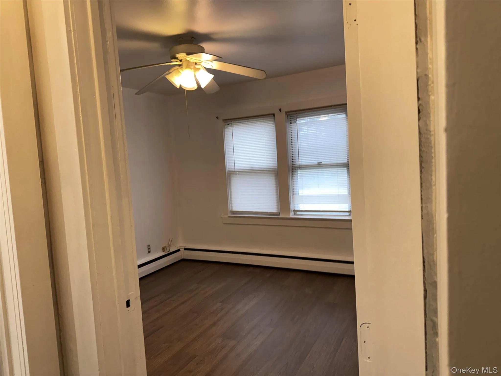 Bedroom with dark wood-style flooring, ceiling fan,  baseboard Bedroom with dark wood-style flooring, ceiling fan,  baseboard