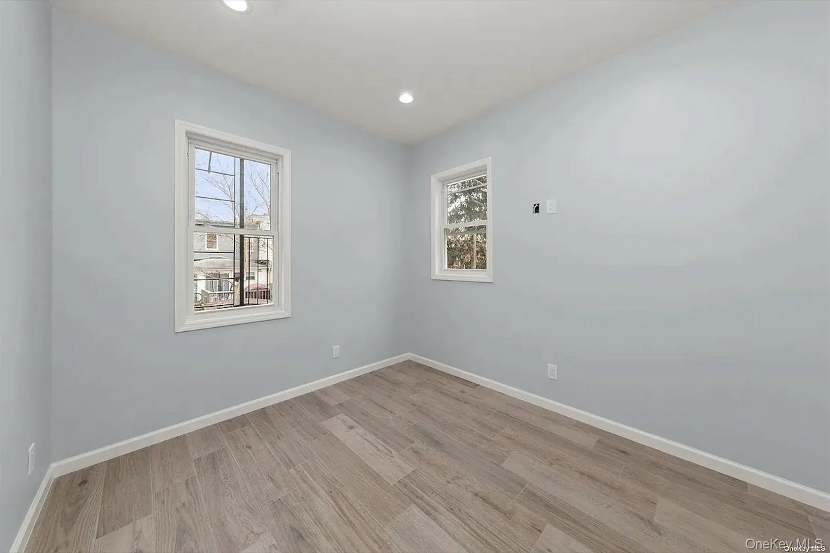 Spare room with light wood-type flooring and recessed lighting Spare room with light wood-type flooring and recessed lighting