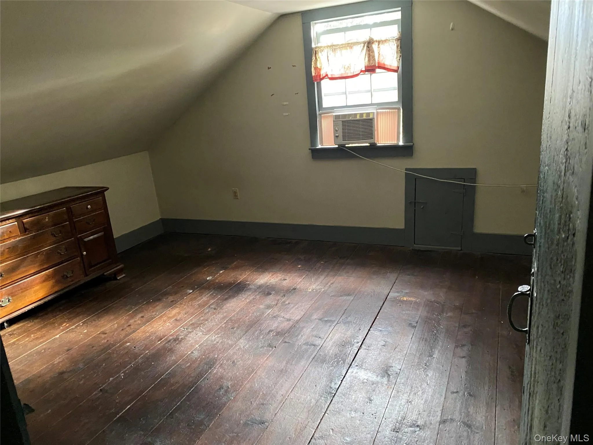 Additional living space with dark wood-style floors, lofted ceiling, and cooling unit Additional living space with dark wood-style floors, lofted ceiling, and cooling unit