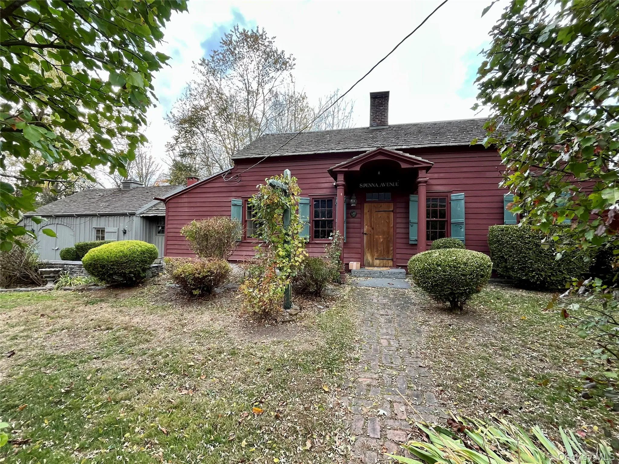 View of front of property featuring a chimney and a front yard View of front of property featuring a chimney and a front yard
