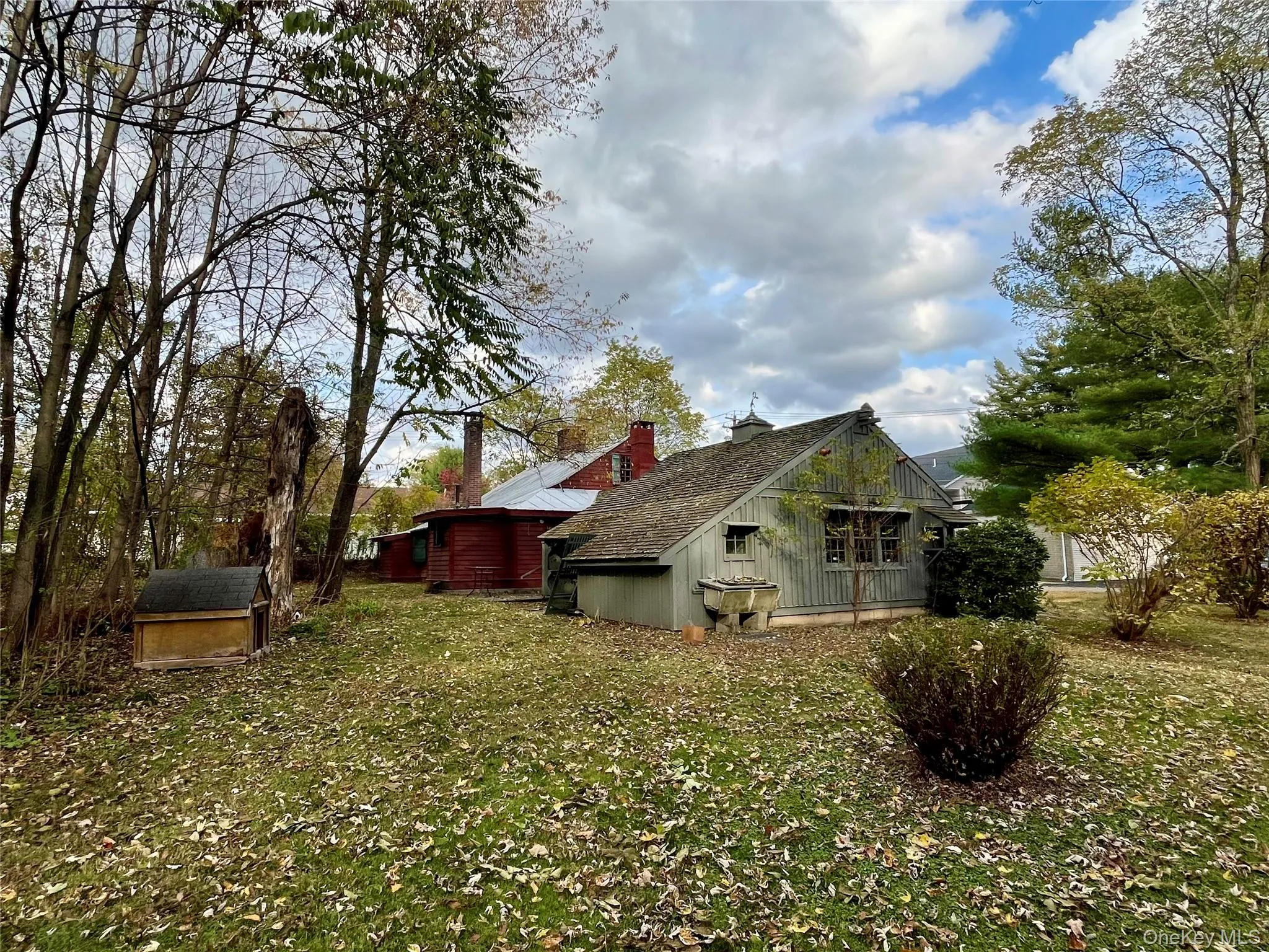 View of side of home featuring a yard and a storage shed View of side of home featuring a yard and a storage shed