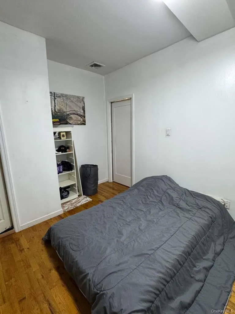 Bedroom featuring wood finished floors and baseboards Bedroom featuring wood finished floors and baseboards