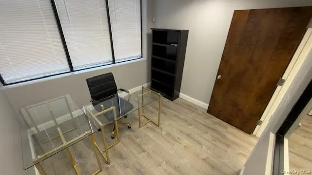 Office area featuring light wood-style flooring and baseboards Office area featuring light wood-style flooring and baseboards