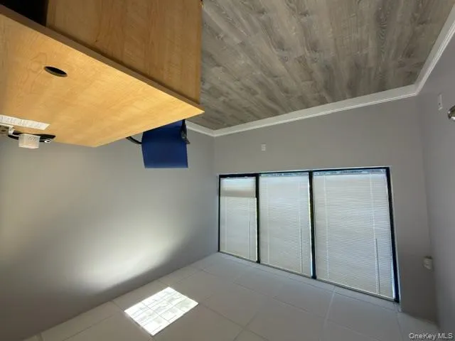 Unfurnished office featuring a drop ceiling and light wood-style floors Unfurnished office featuring a drop ceiling and light wood-style floors