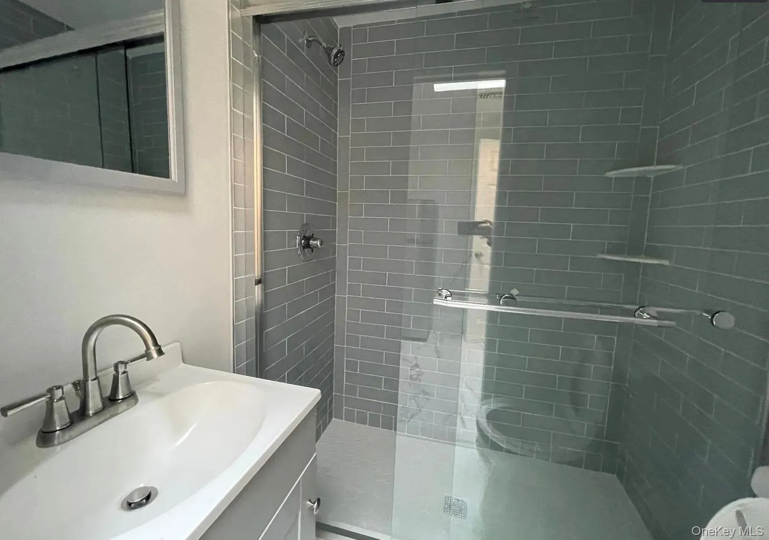 Bathroom with a shower stall and vanity Bathroom with a shower stall and vanity