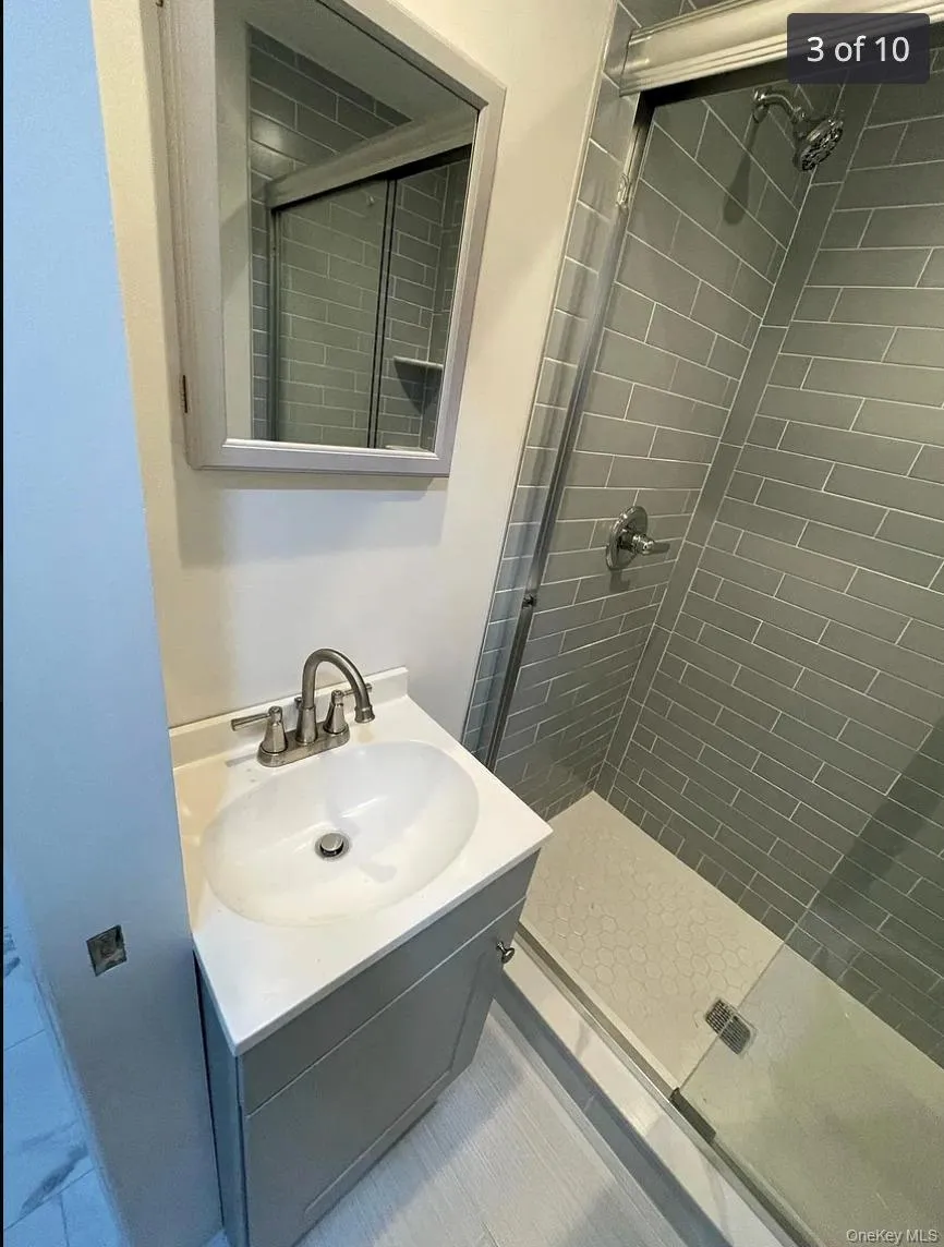 Full bathroom with vanity and a shower stall Full bathroom with vanity and a shower stall