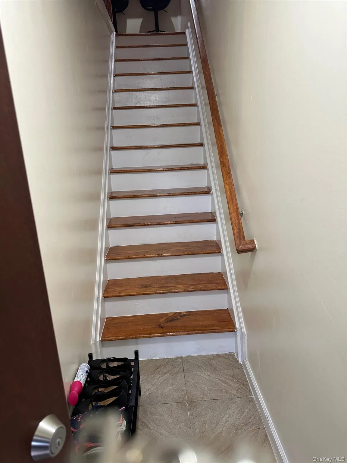 Stairs featuring tile patterned floors Stairs featuring tile patterned floors