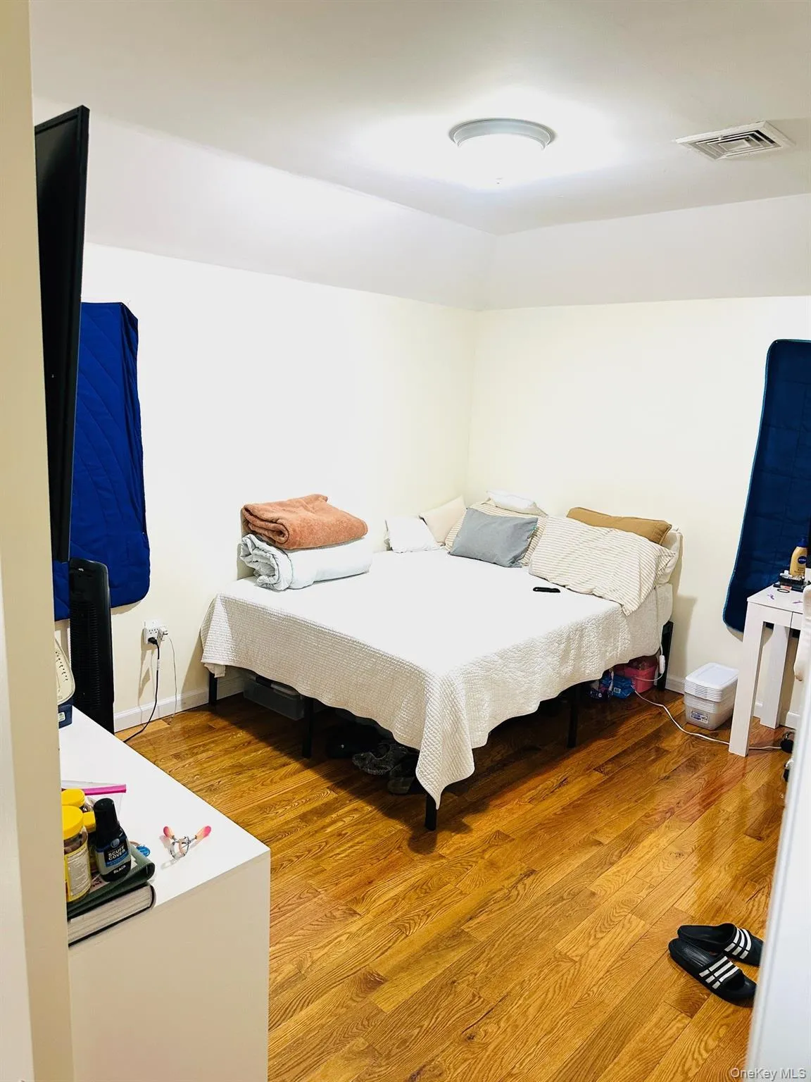 Bedroom with light wood finished floors and baseboards Bedroom with light wood finished floors and baseboards