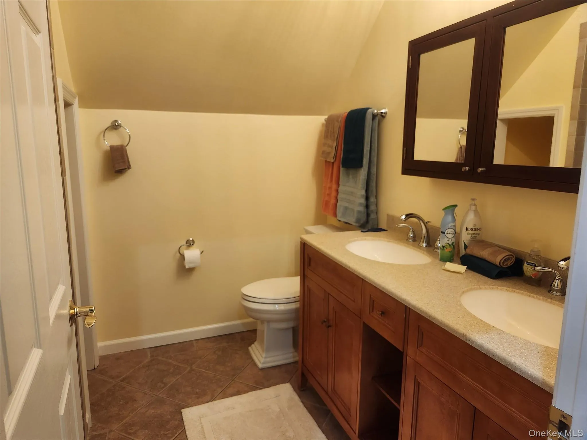2nd Floor Bathroom with tile patterned floors, vanity, toilet, and vaulted ceiling 2nd Floor Bathroom with tile patterned floors, vanity, toilet, and vaulted ceiling