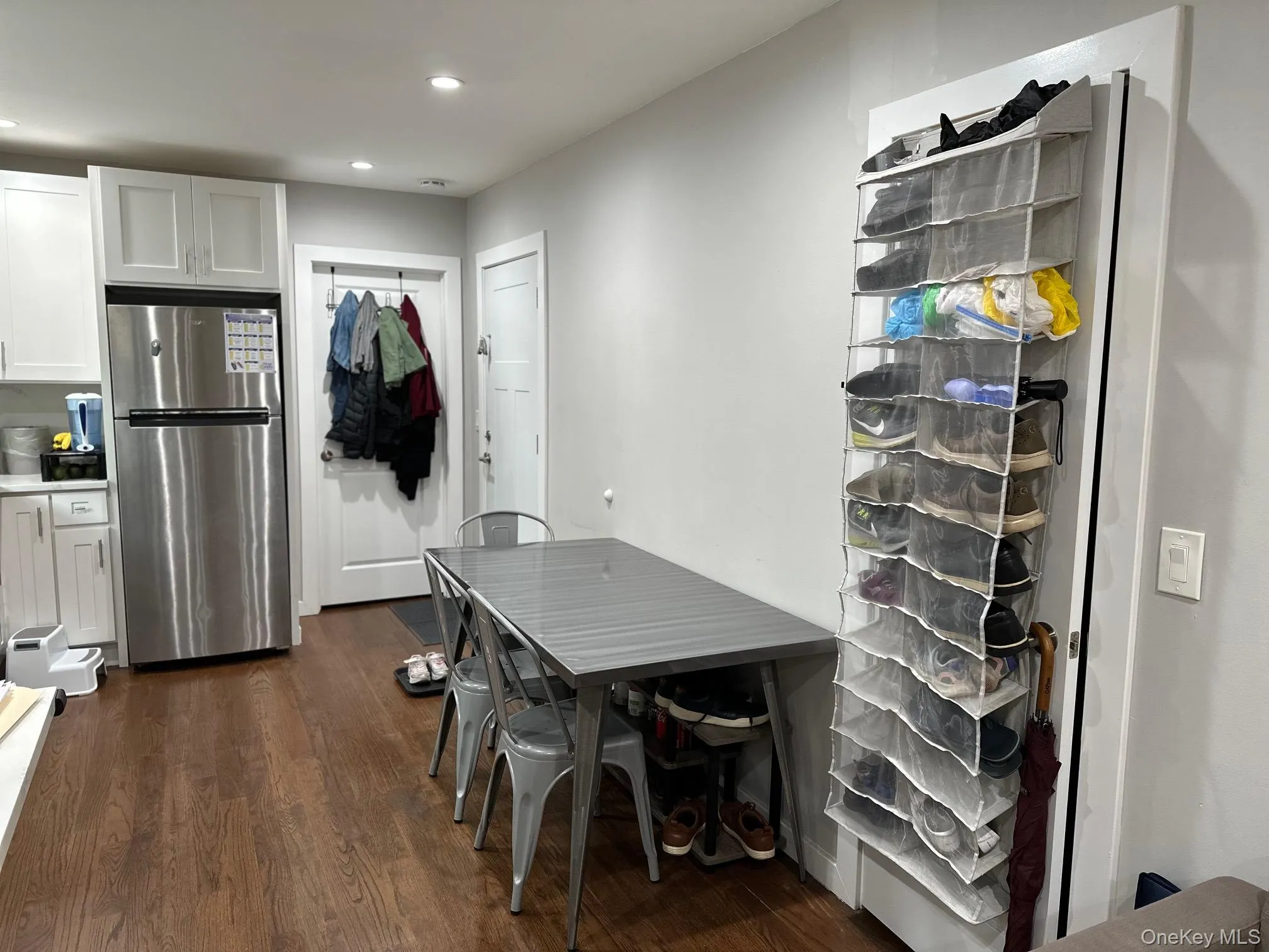 Dining space with dark wood-style flooring and recessed lighting Dining space with dark wood-style flooring and recessed lighting