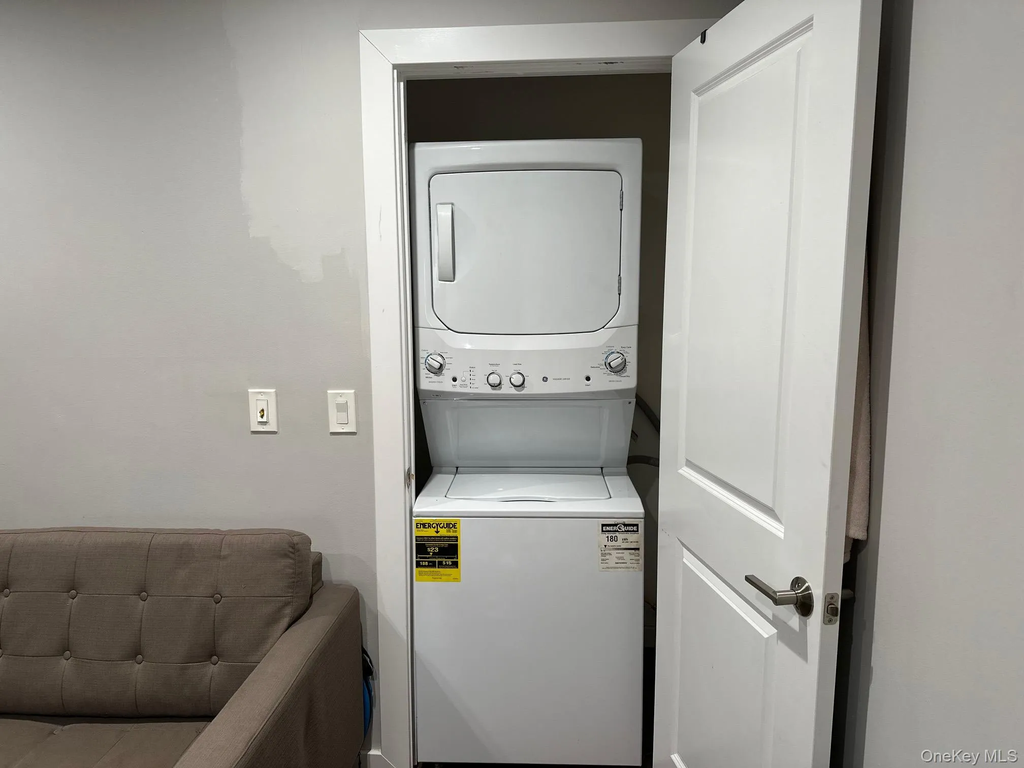 Laundry area featuring stacked washer / drying machine Laundry area featuring stacked washer / drying machine