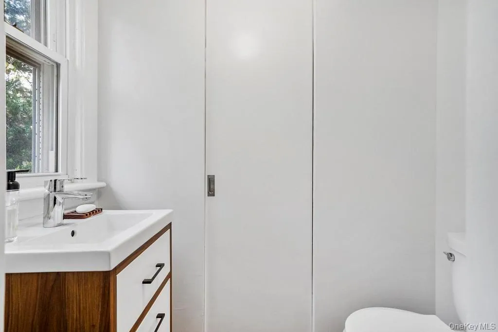 Half bathroom featuring vanity and toilet Half bathroom featuring vanity and toilet