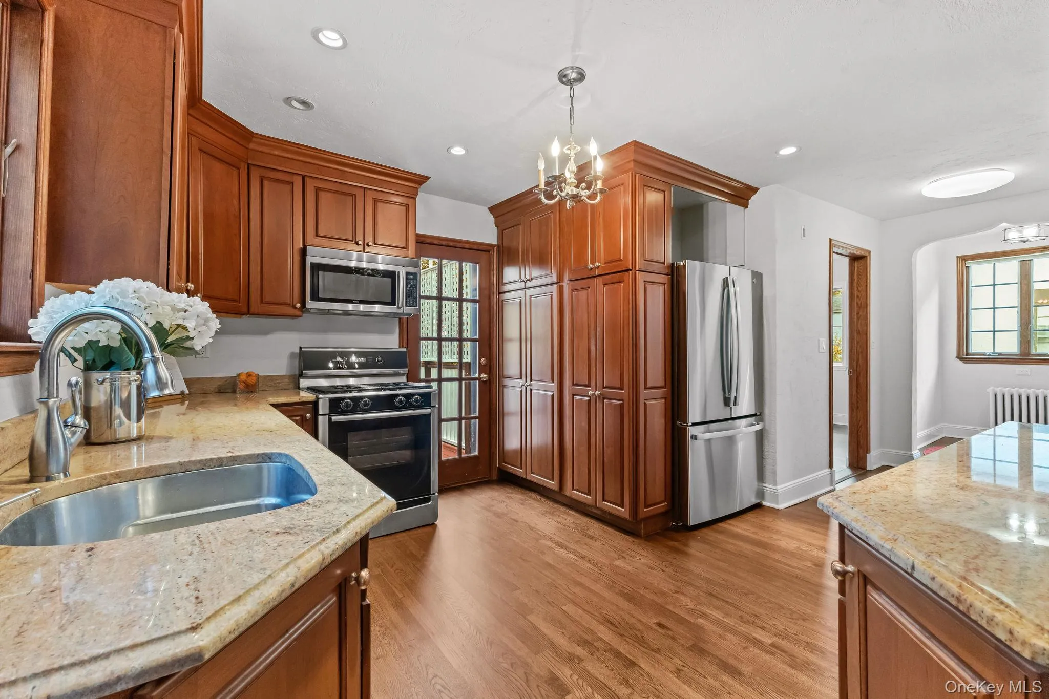Kitchen featuring light stone countertops, stainless steel appliances, , and recessed lighting Kitchen featuring light stone countertops, stainless steel appliances, , and recessed lighting