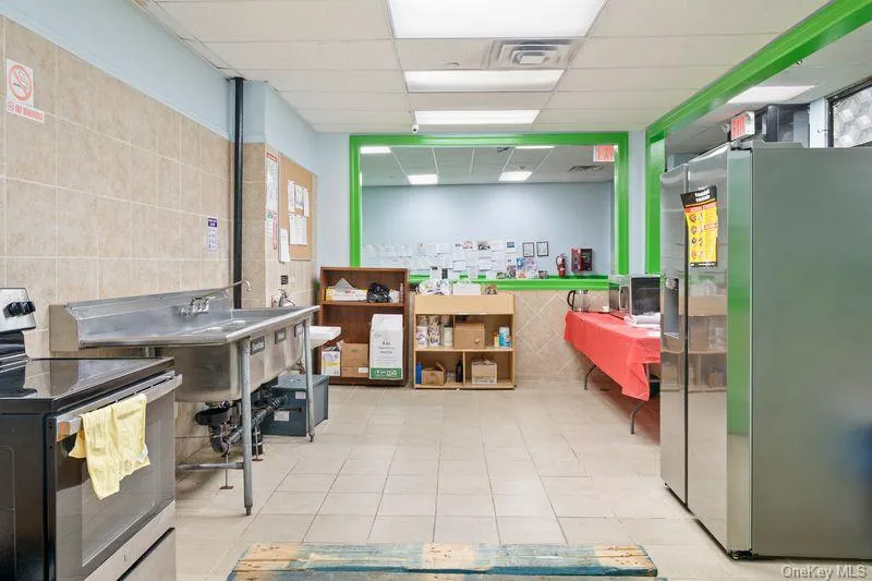 Home office featuring tile walls and a drop ceiling Home office featuring tile walls and a drop ceiling