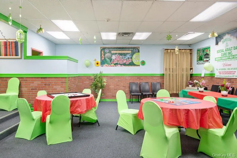 Rec room with a paneled ceiling, a wainscoted wall, and brick wall Rec room with a paneled ceiling, a wainscoted wall, and brick wall