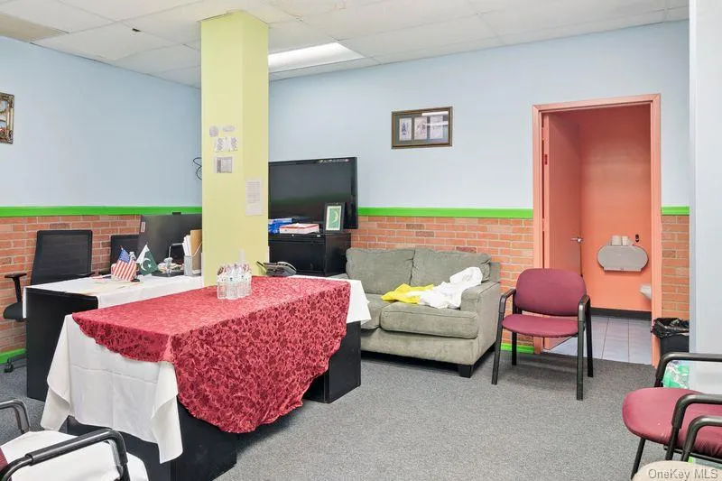Carpeted dining area with a drop ceiling and a wainscoted wall Carpeted dining area with a drop ceiling and a wainscoted wall