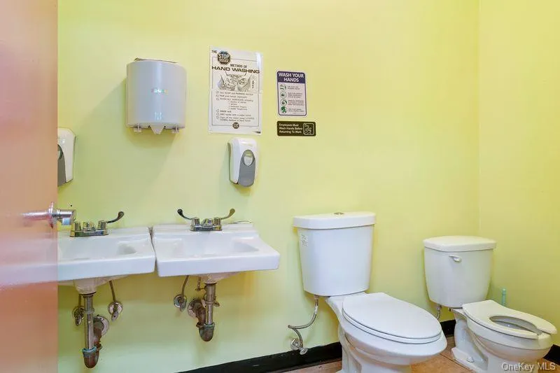 Half bath with toilet and a sink Half bath with toilet and a sink