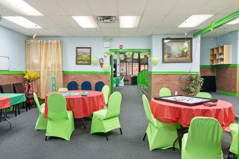 Rec room with a paneled ceiling, wainscoting, and brick wall Rec room with a paneled ceiling, wainscoting, and brick wall