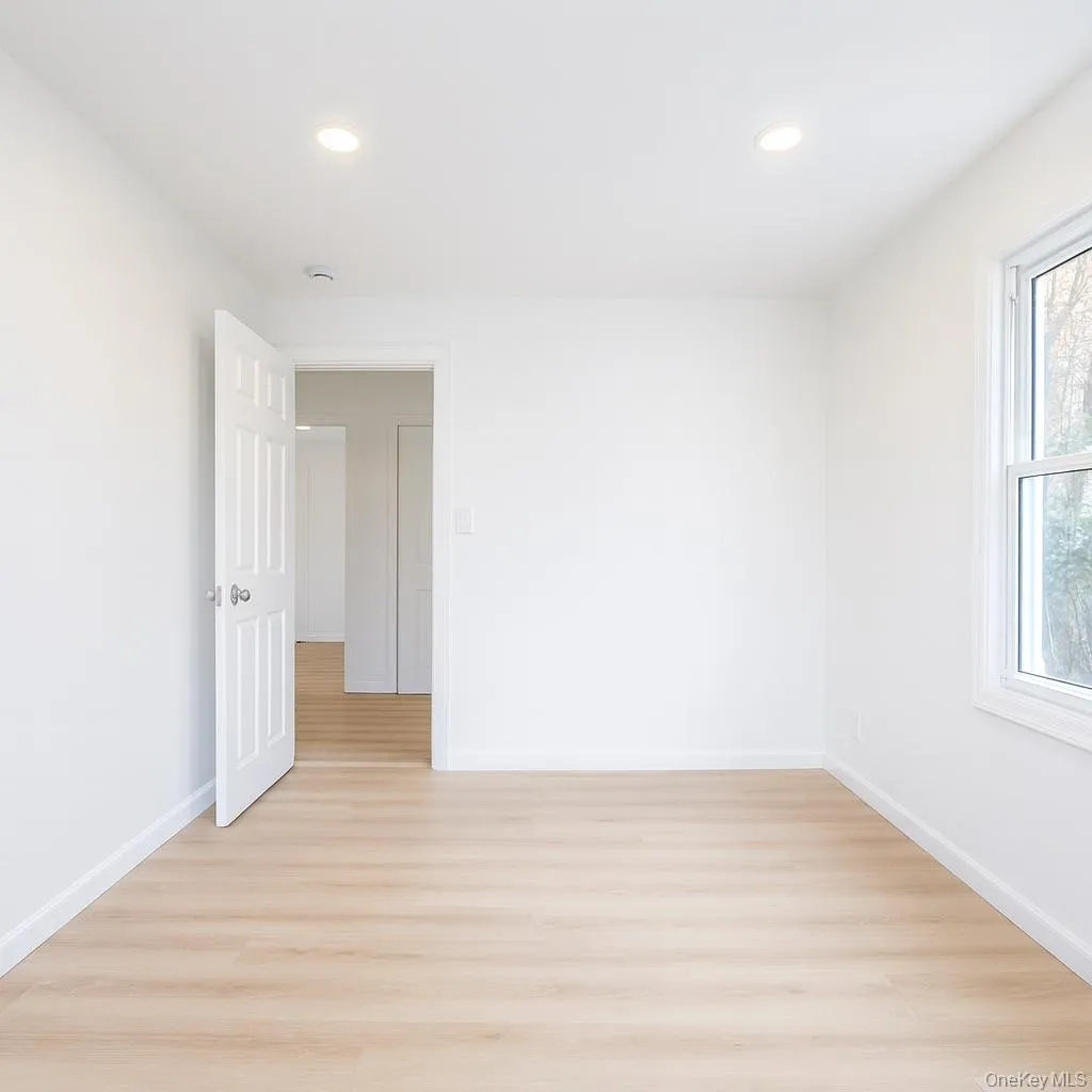 Ground level bedroom with light wood finished floors and recessed lighting Ground level bedroom with light wood finished floors and recessed lighting
