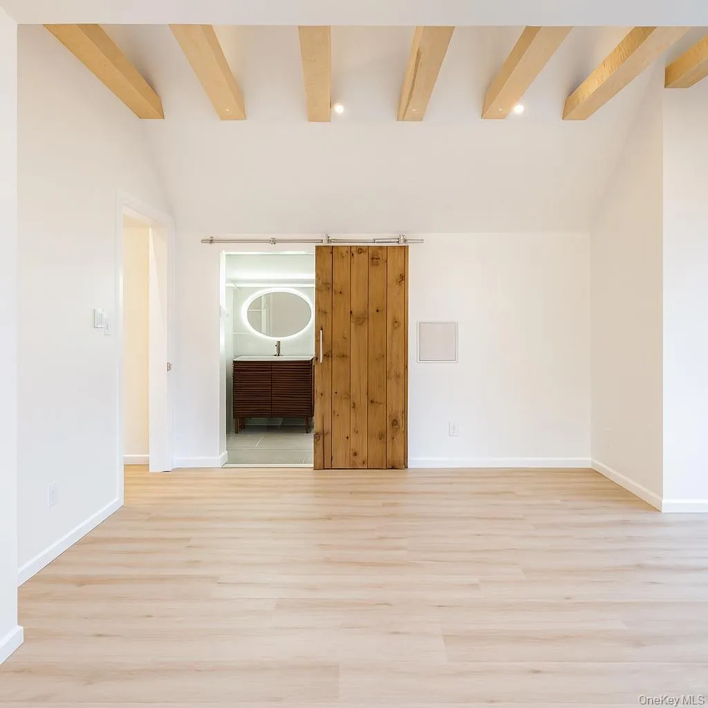 Primary bedroom with full bath and light wood-style floors and recessed lighting Primary bedroom with full bath and light wood-style floors and recessed lighting