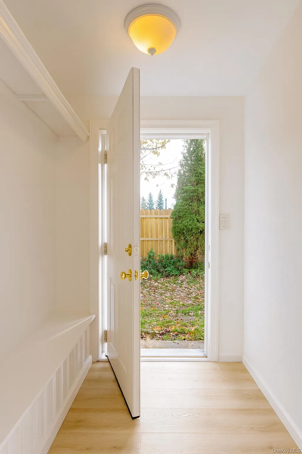 Mudroom with light wood-style flooring and baseboards Mudroom with light wood-style flooring and baseboards
